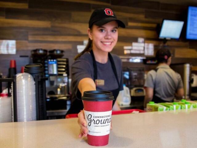 Barista with coffee at Connecting Grounds