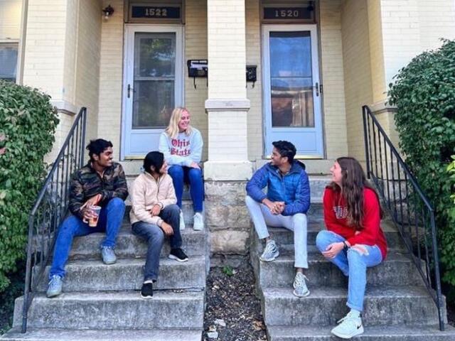 Students sitting on an off-campus porch